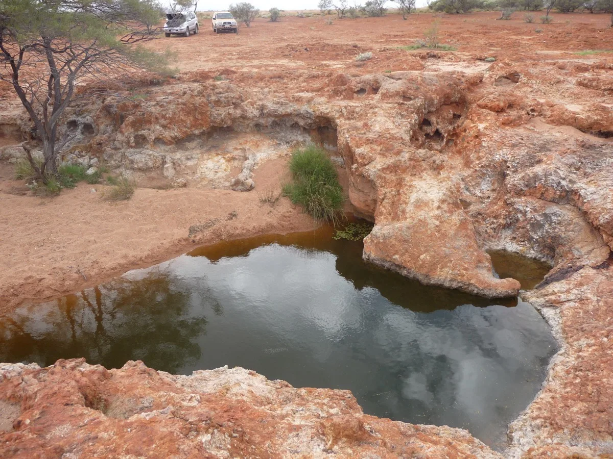 Desert waterhole: precious resource carved into ancient outback stone
