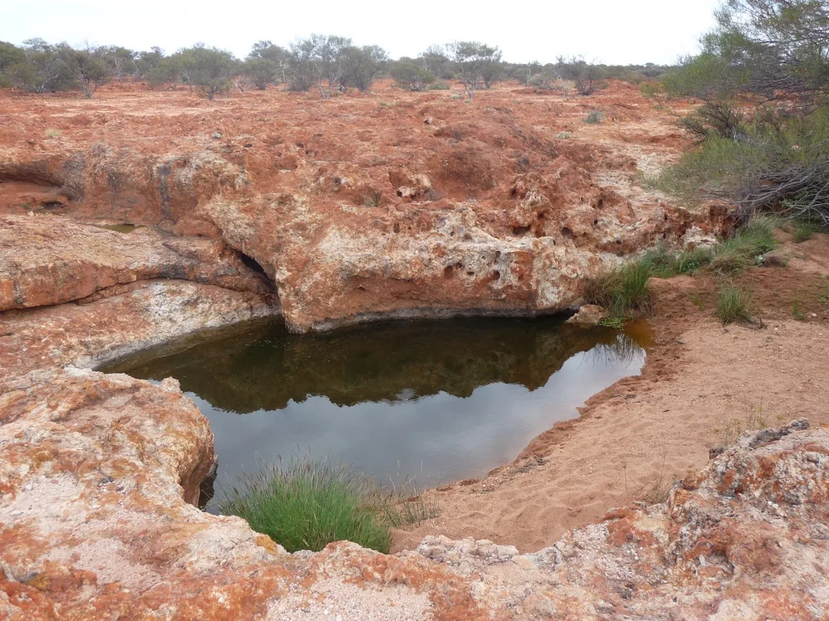 Hidden desert oasis among ancient red rock formations