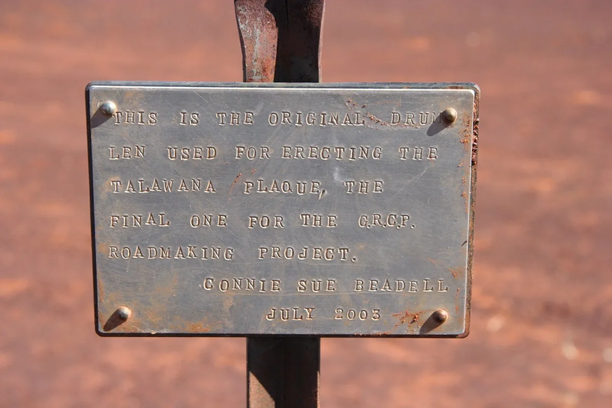 Historic plaque marking outback road development history