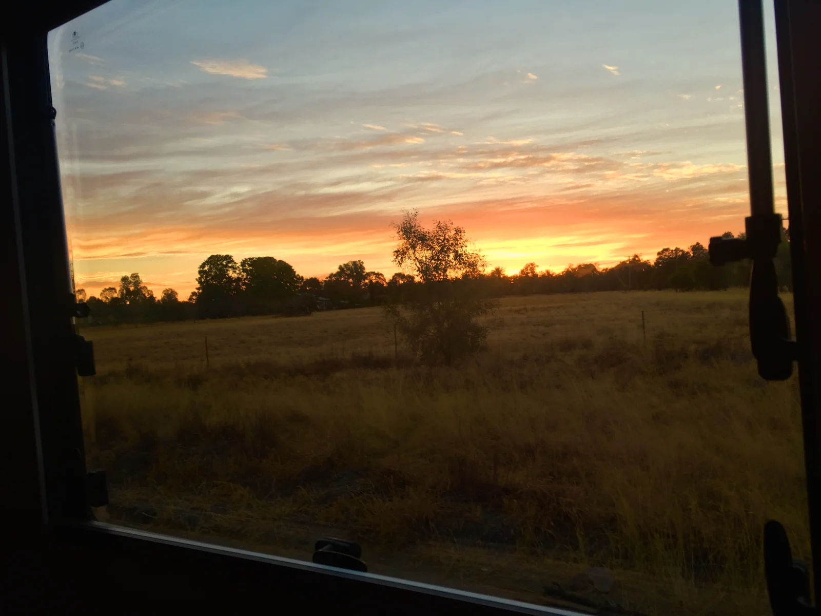 Spectacular sunset viewed from caravan window in outback