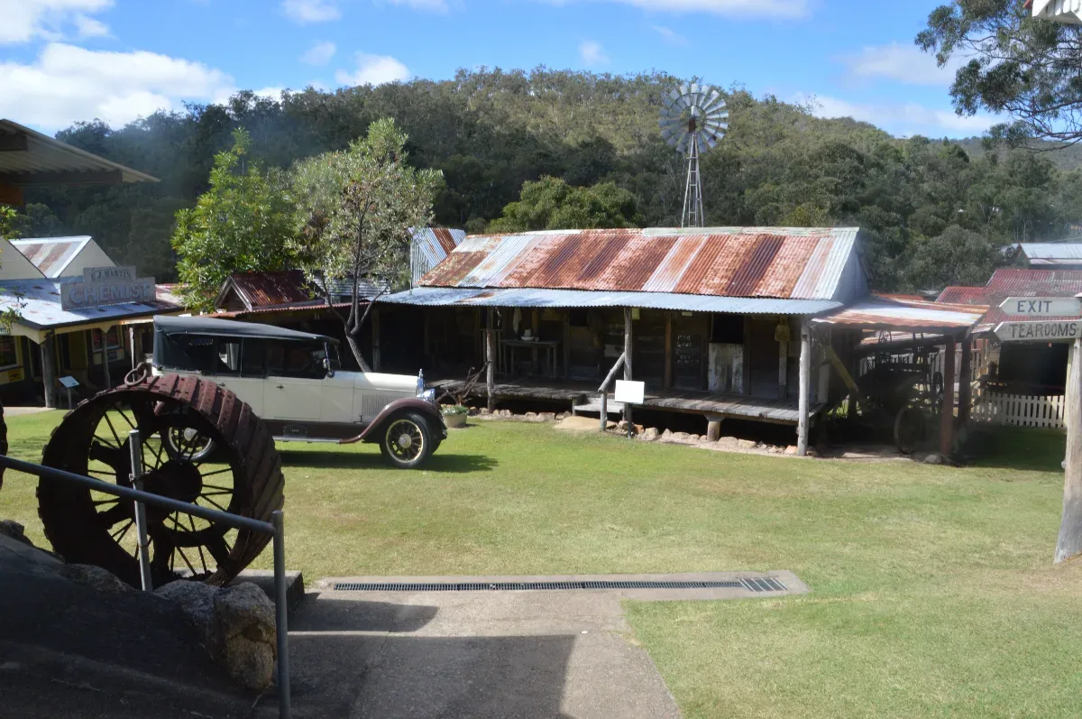 A general view of the village, showcasing the carefully preserved buildings and vintage vehicles.