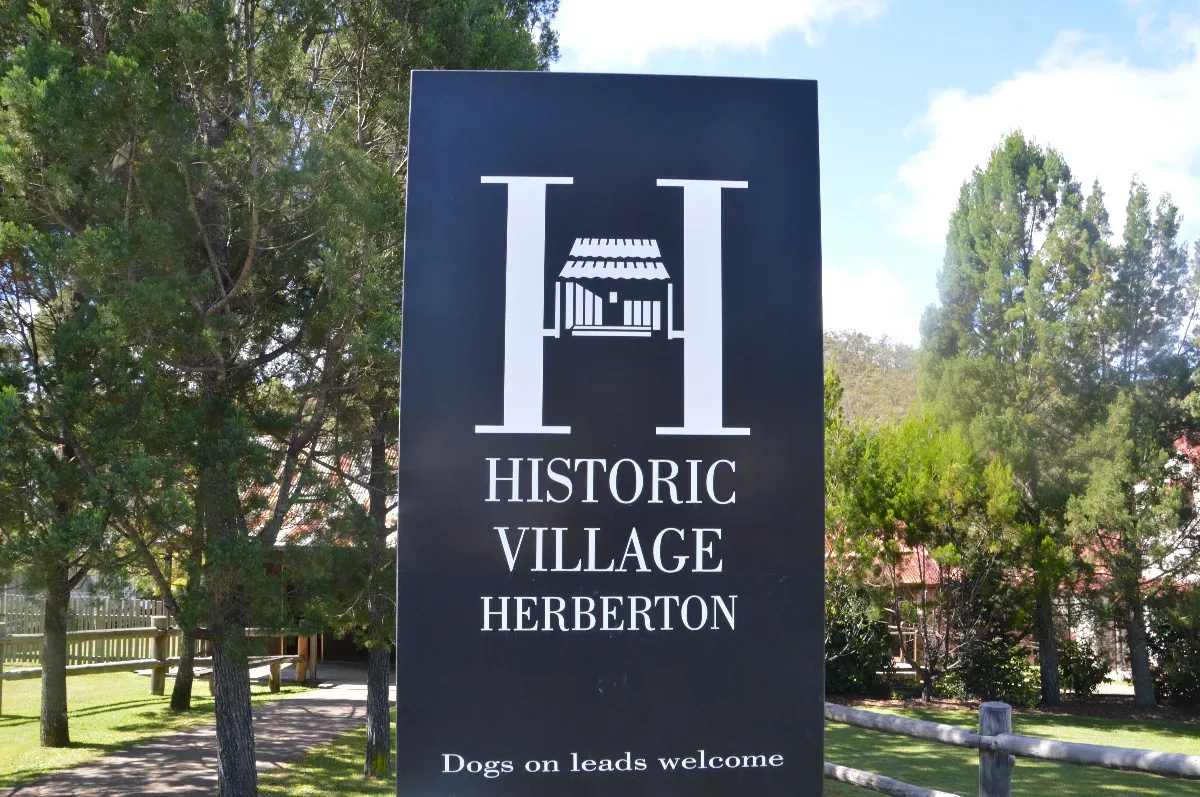 The welcoming sign for Herberton Historic Village, promising a journey into the past.