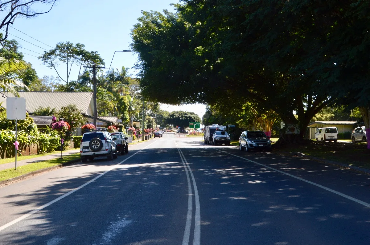 Yungaburra's main street, lined with verdant trees, exudes small-town charm and peaceful ambiance.
