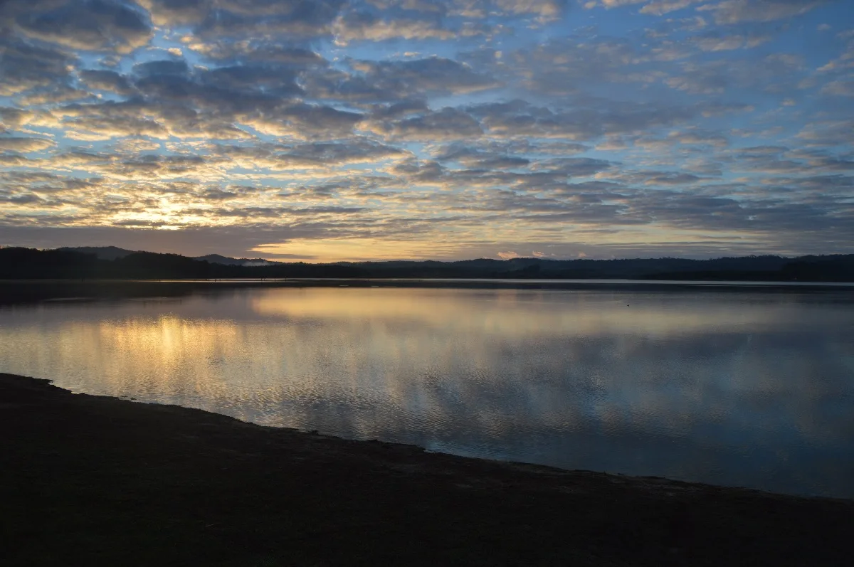 The lake reflecting the early morning sky, a breathtaking start to the day.