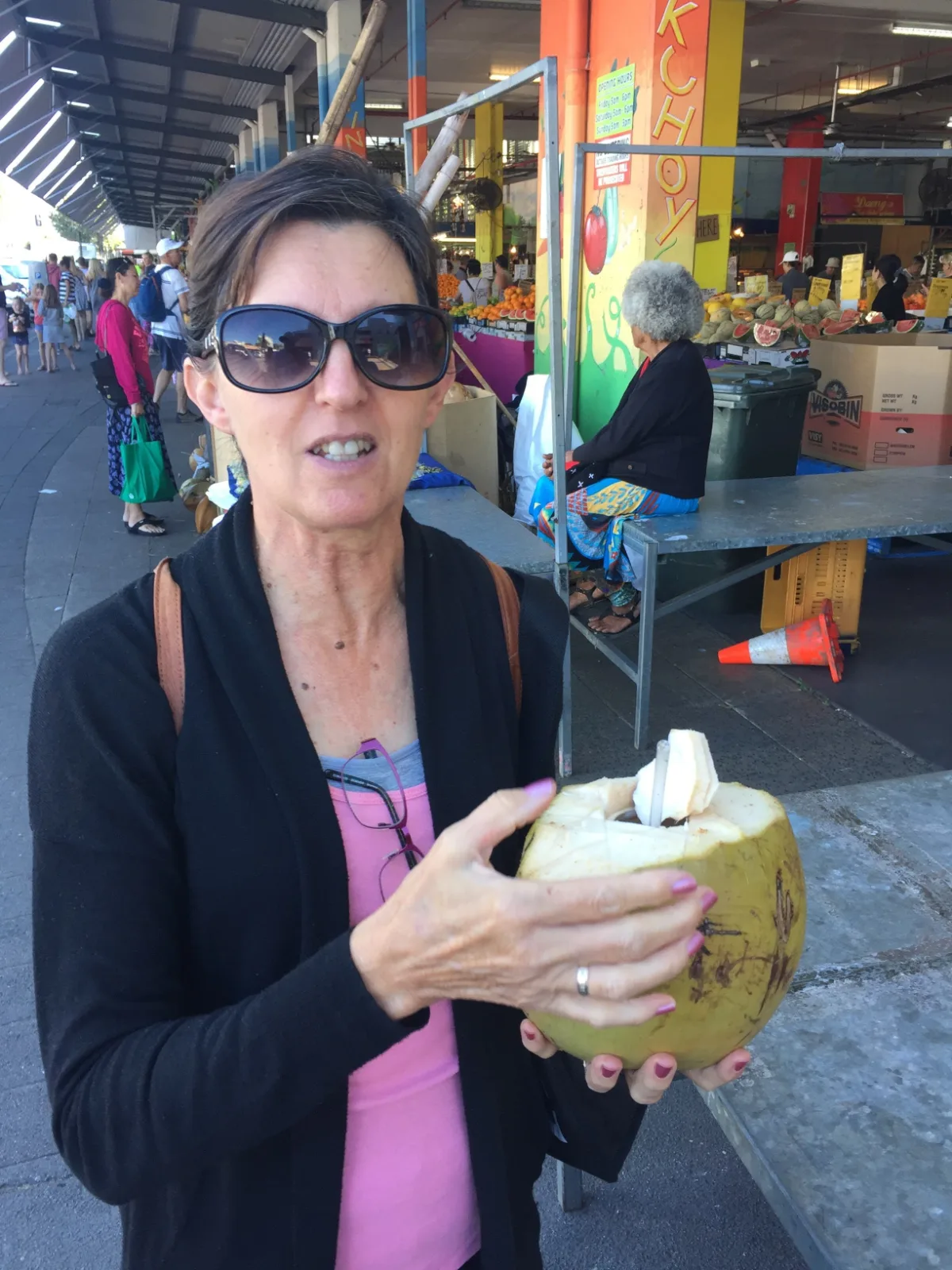 Lisa proudly displays her freshly prepared coconut at the Cairns Night Markets, a moment years in the making.