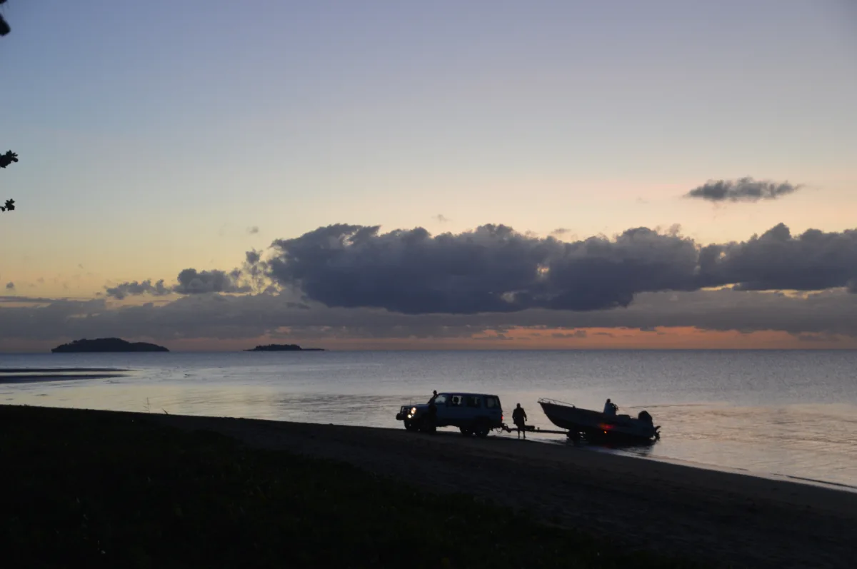 An early start for some, as a boat is launched into the calm waters.