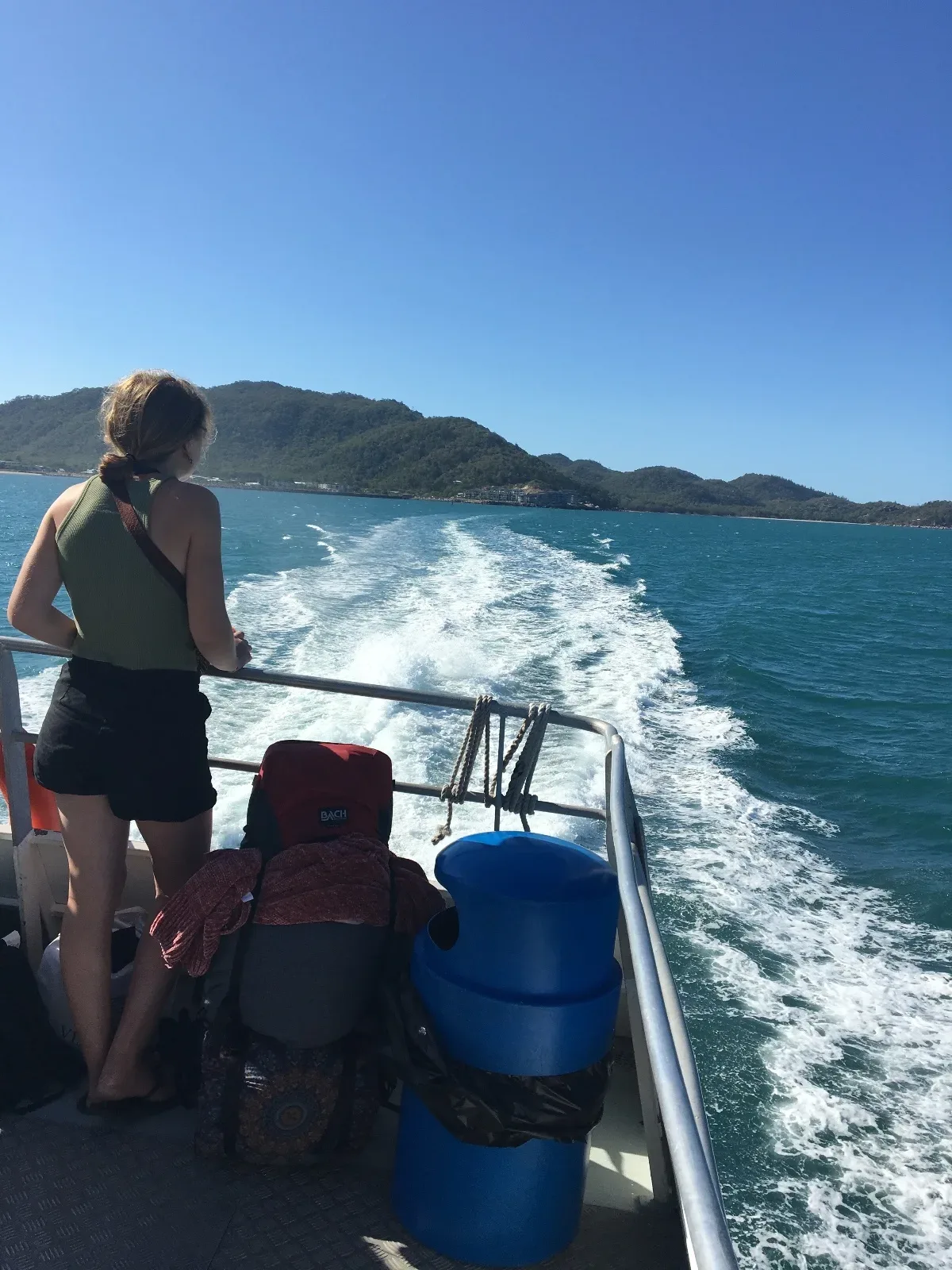 A solitary figure enjoys the view from the back of the Magnetic Island ferry.