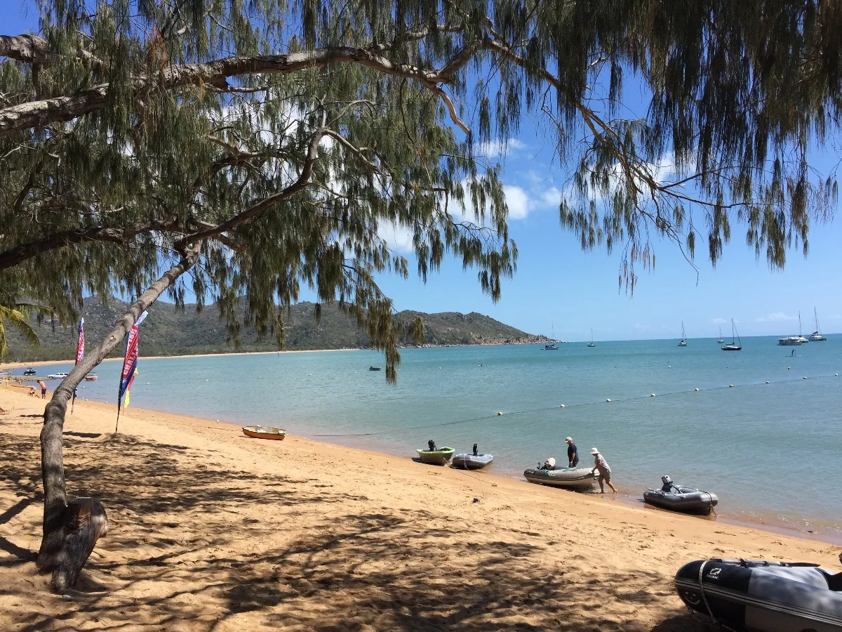 The tranquil waters of Florence Bay, dotted with boats enjoying the tropical sun.
