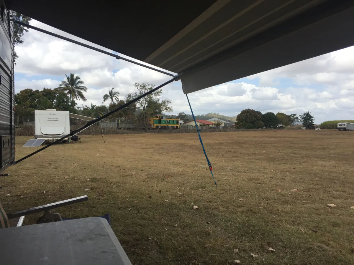 Relaxing under our awning, we look out onto the expansive field towards a vintage rail car, a silent monument to Gargett's rich history.