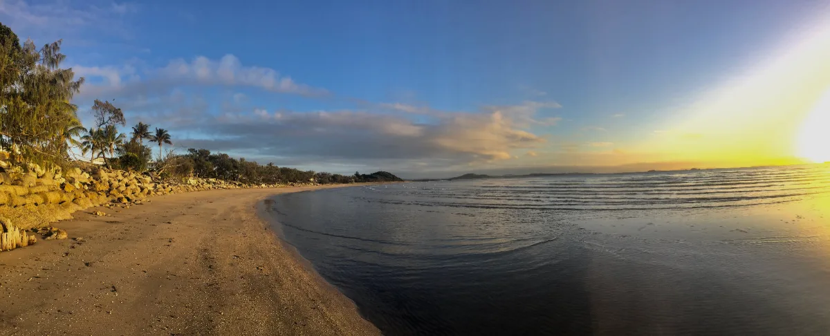 The sun rises over the beach, greeting a new day.