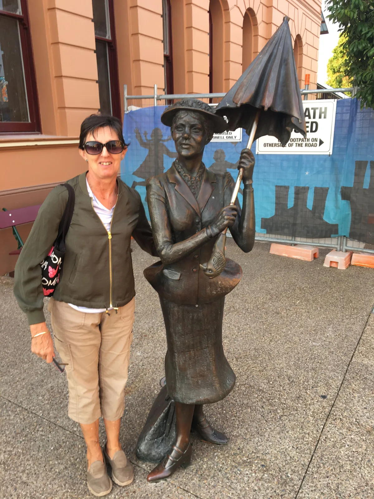Lisa poses with the bronze statue of Mary Poppins in her birthplace of Maryborough.