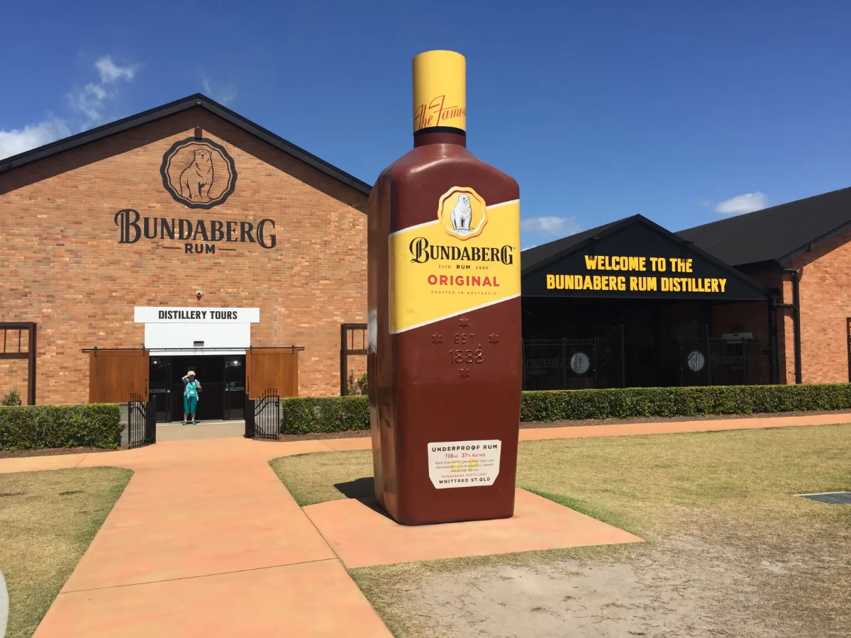 The entrance to the Bundaberg Rum Distillery, guarded by a monument to its most famous product.