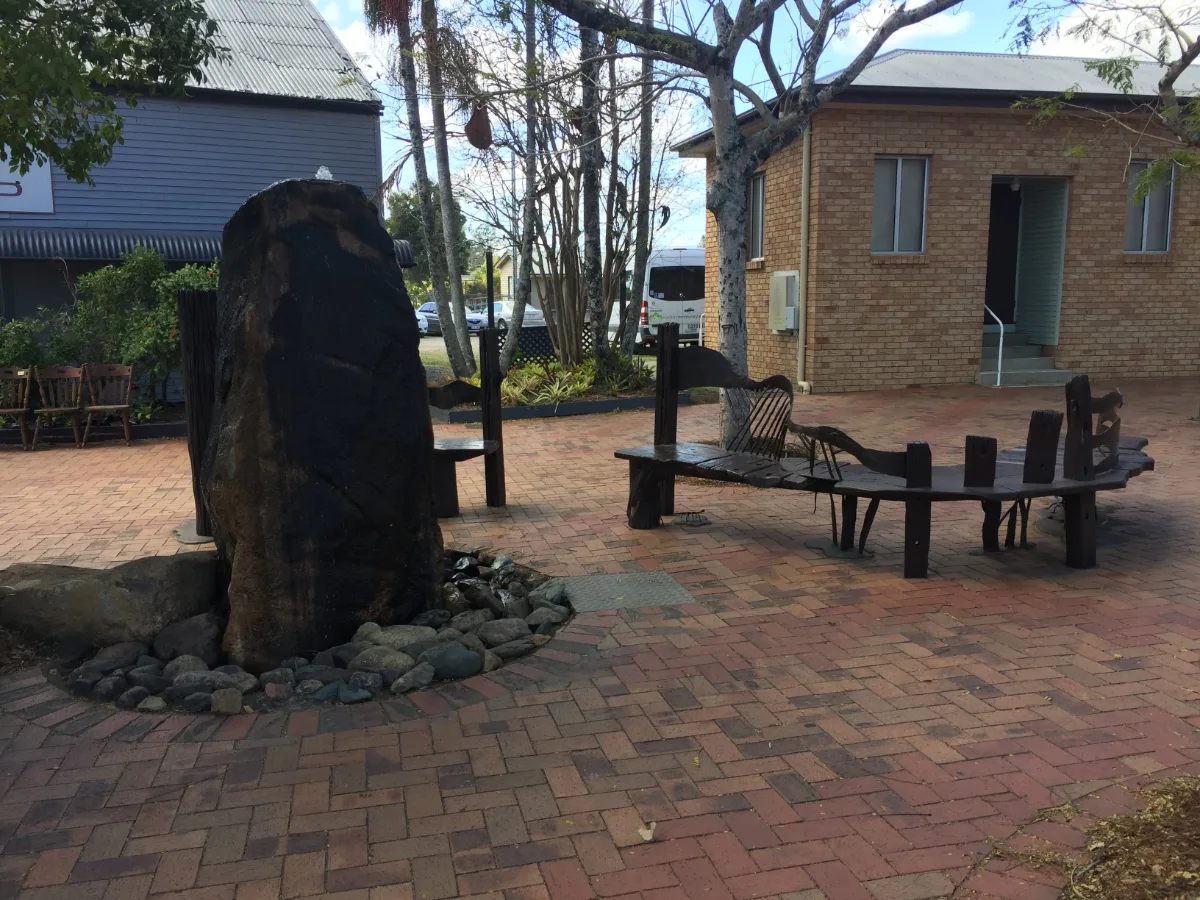 The town square's water feature, complete with rustic seating, provides a quiet spot for contemplation.