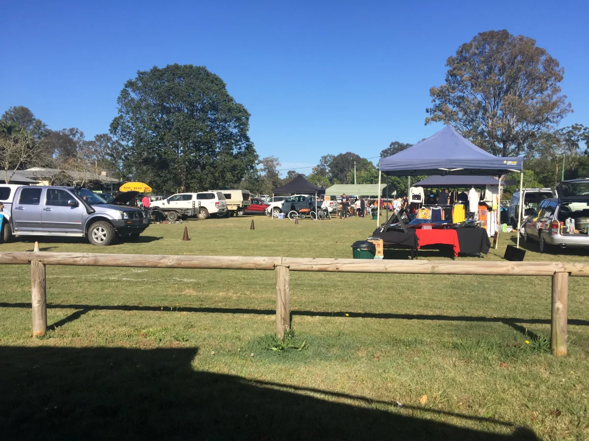 A wide view of the Eumundi Markets, showing the stalls spread across the field.