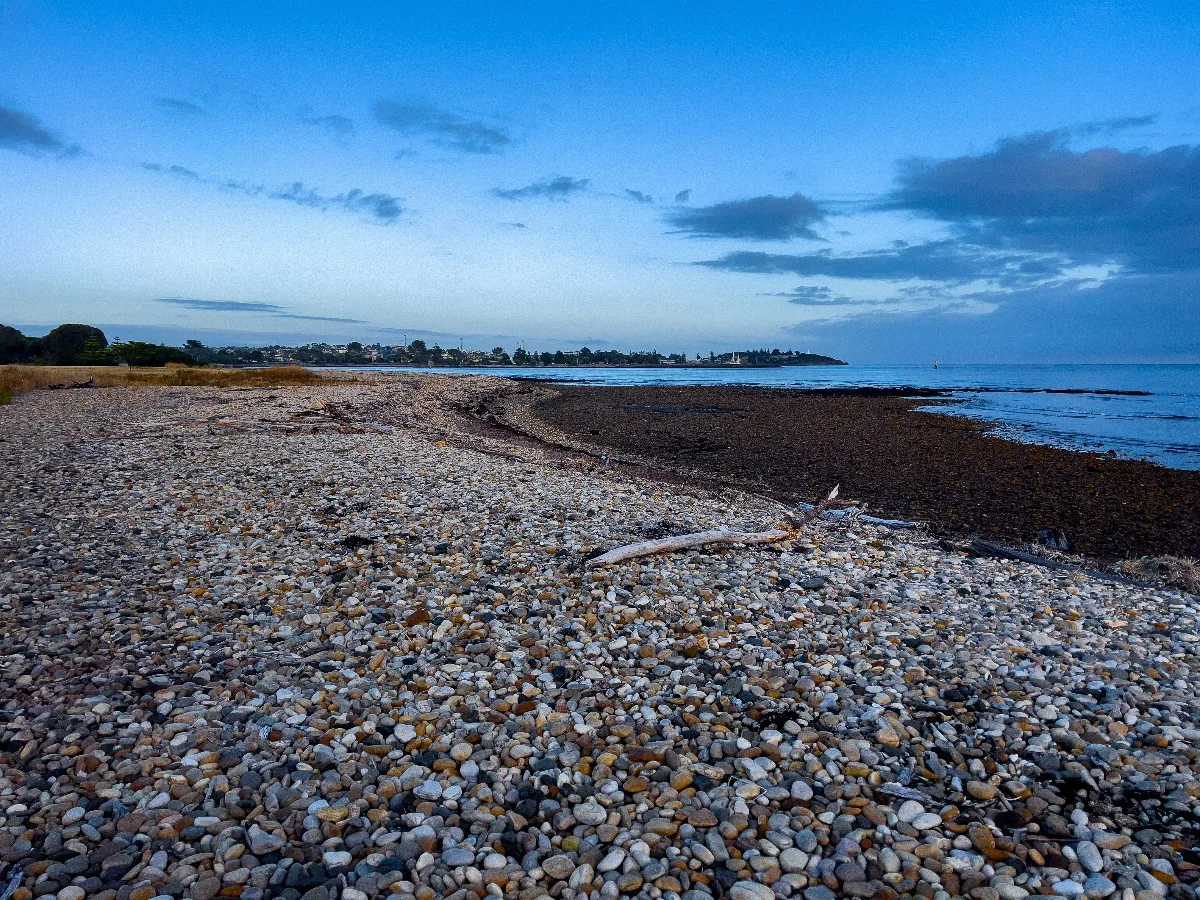 The stone beach at Devonport stretched out towards the Bass Strait, awaiting the high tide.