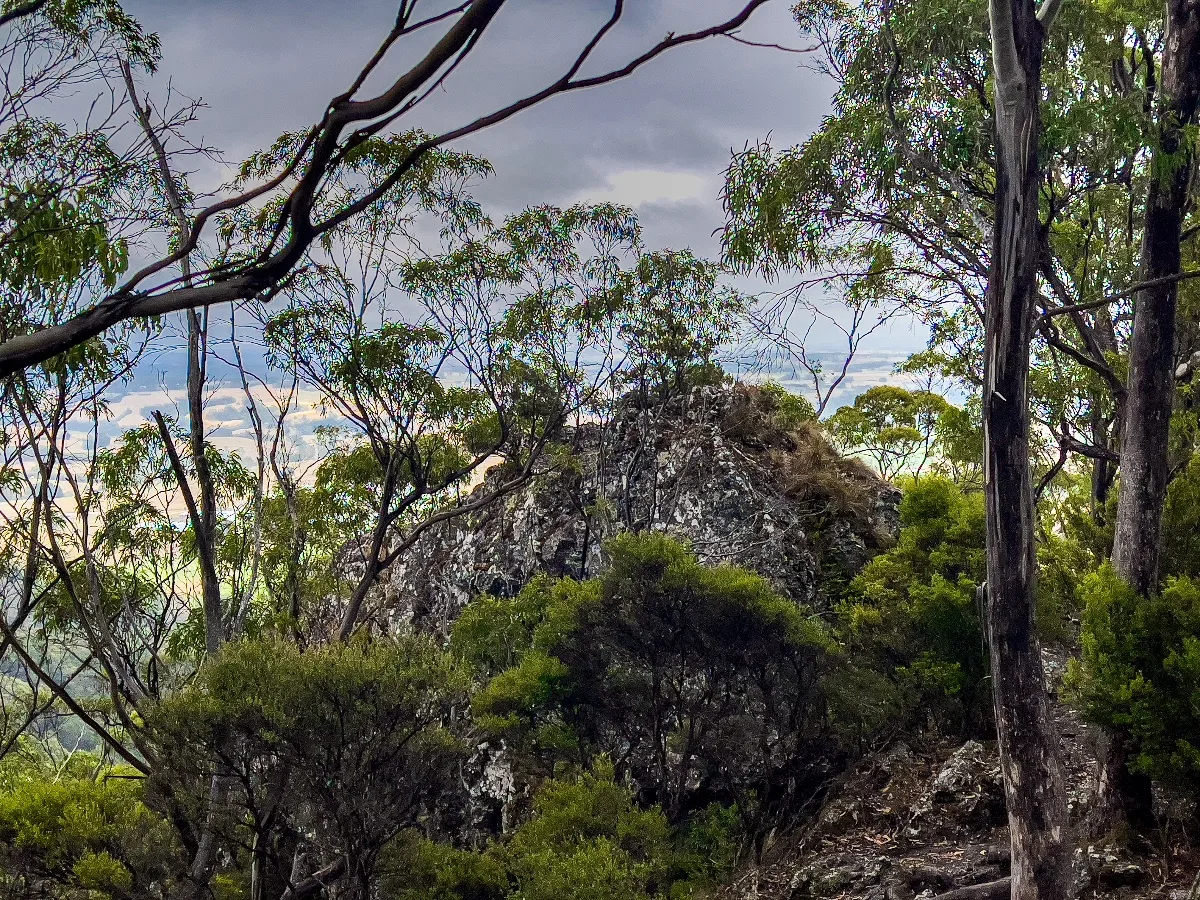 A rocky outcrop on the way up Mount Gnomon offers a tantalizing glimpse of the views to come.