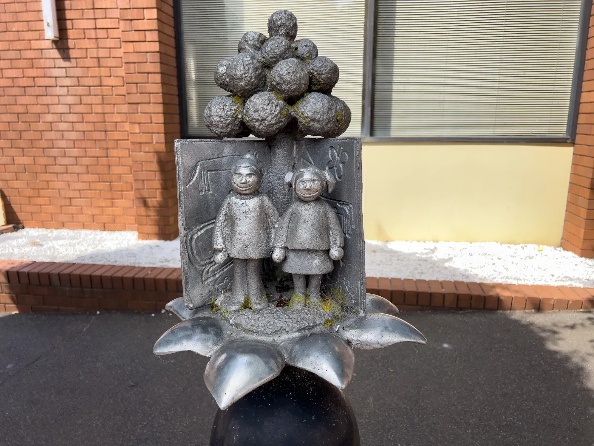 A quaint statue of two children under a tree, another example of Deloraine's public art.