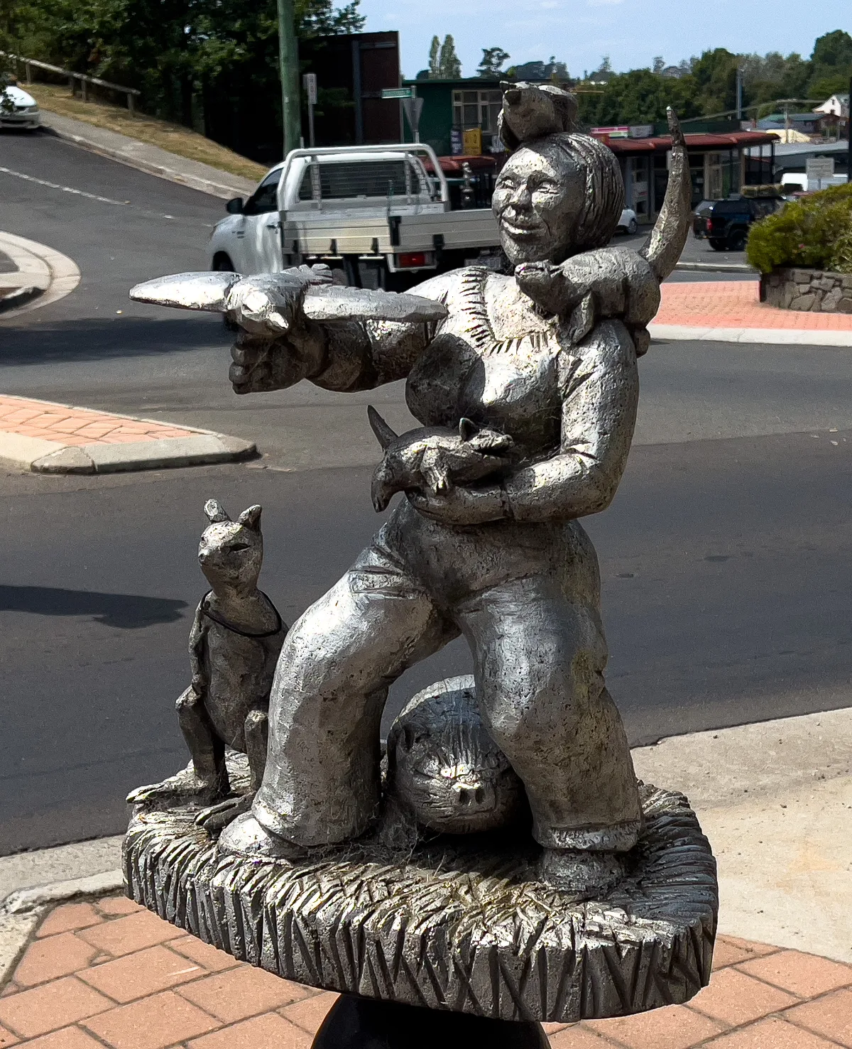 A whimsical sculpture of a woman surrounded by animals, showcasing Deloraine's unique artistic sensibility.