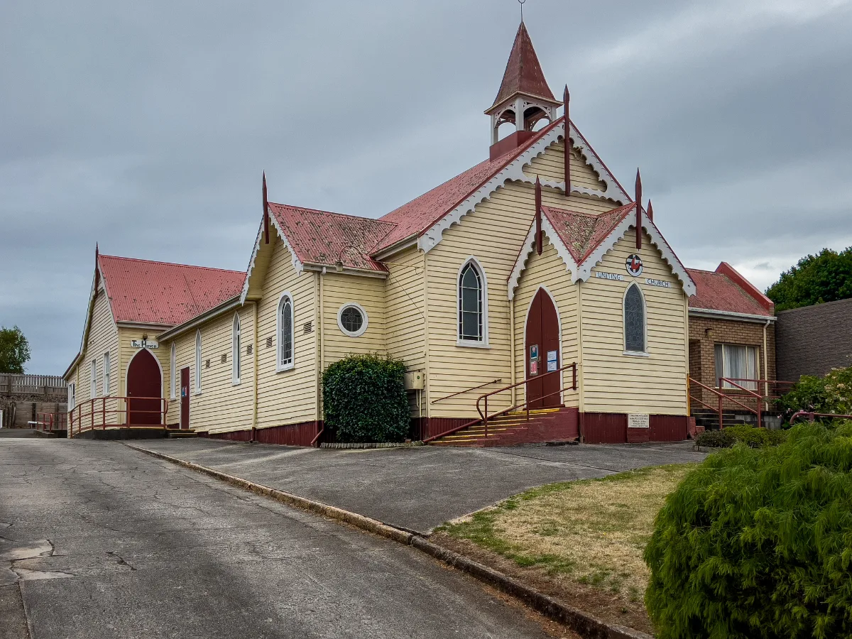 The striking yellow and red timber church that watches over the town of Scottsdale.