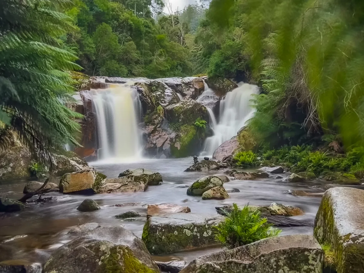 The lower section of the falls, with the water splitting around the rocks and rushing towards us.