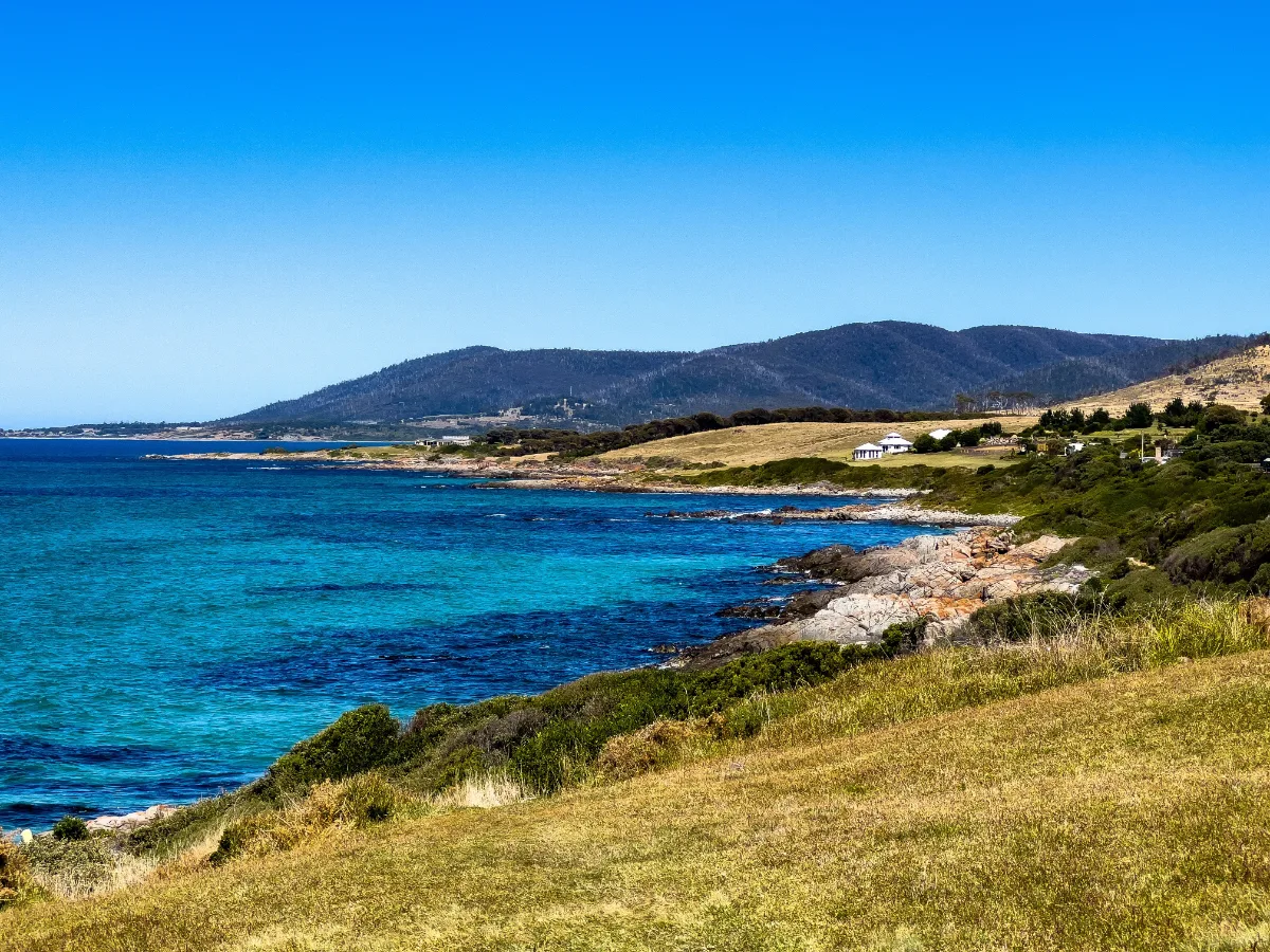 Looking out across the sweeping coastline towards the distant hills near Binalong Bay.