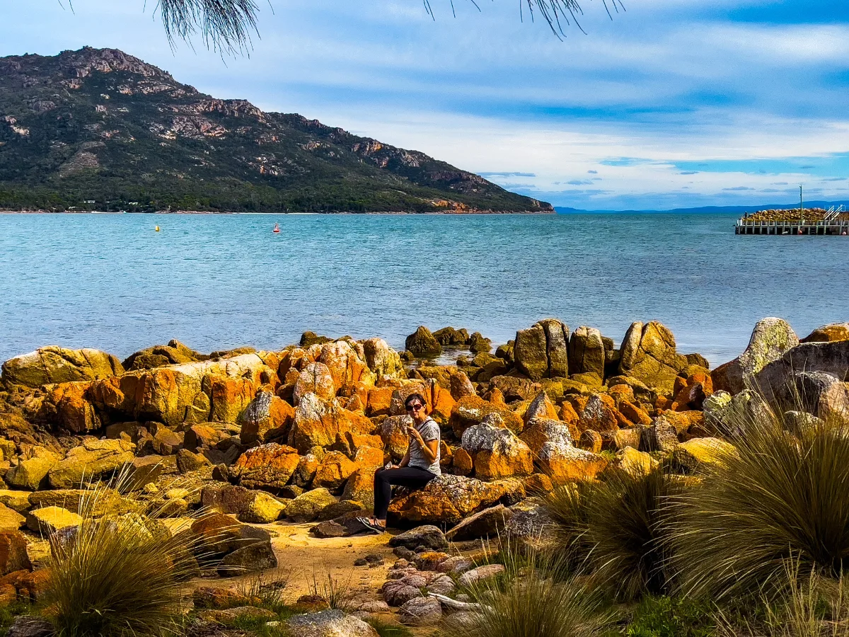 Lisa enjoying a well-earned ice cream while perched on the iconic orange-lichen rocks.