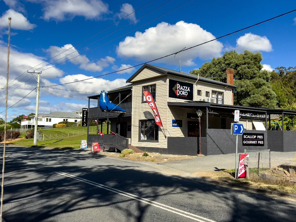 The iconic Blue Seal Cafe standing out bright and bold on the highway at Eaglehawk Neck.