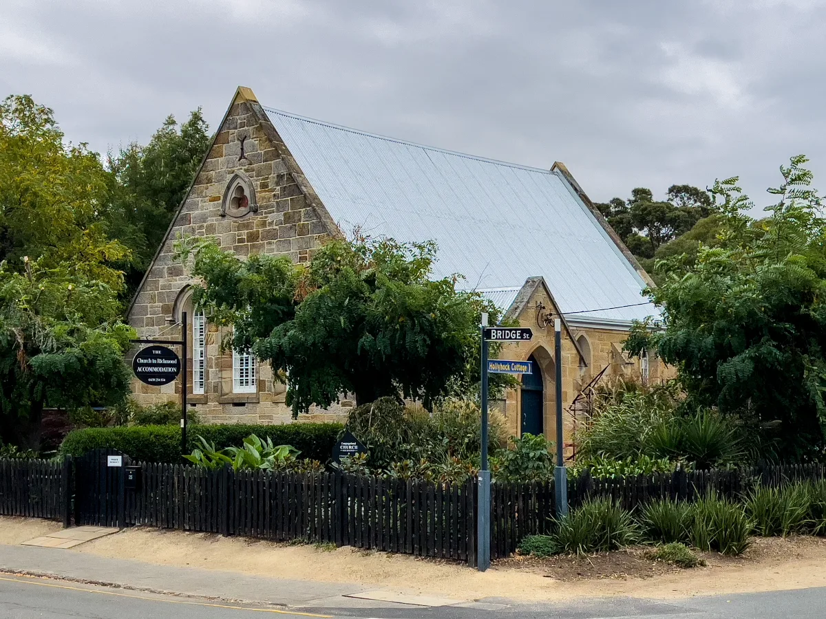 A beautiful old sandstone building in Richmond with a perfectly kept garden.
