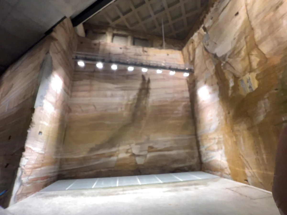 Standing at the base of the massive sandstone walls deep beneath the surface at MONA.