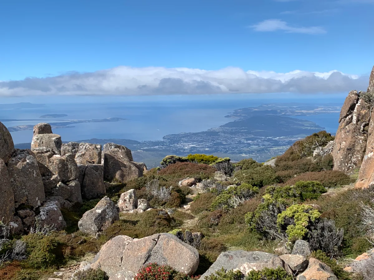 The incredible panoramic view from the top of the mountain, looking out over the rugged rocks and the blue waters of the Derwent.