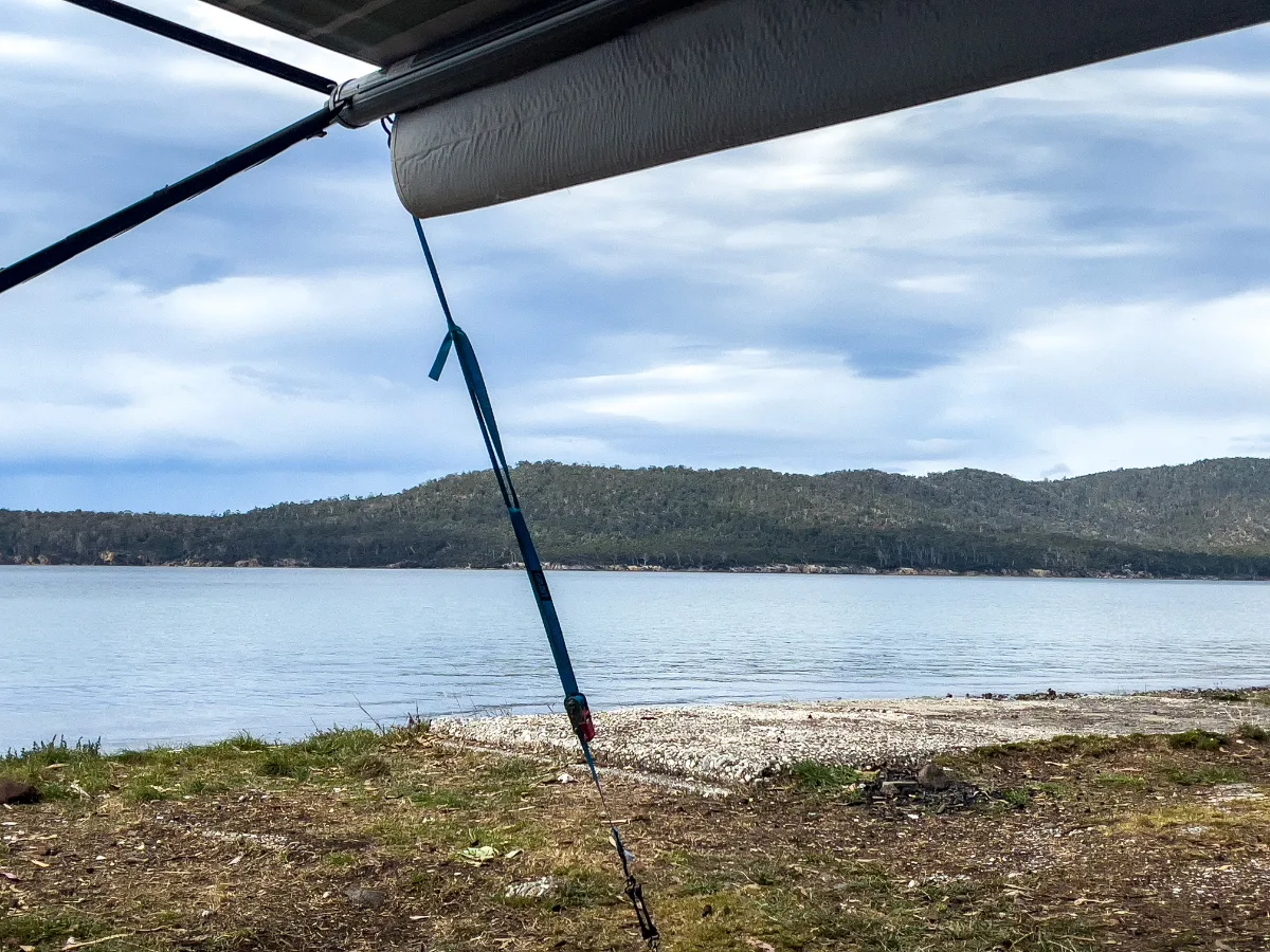 Our front-row seat to the channel, watching the light change over the distant hills from the comfort of the awning.