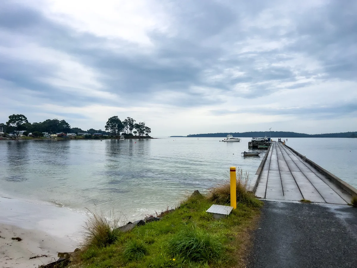 The long concrete boat ramp and jetty at Southport, where the water turns a beautiful shade of pale blue.