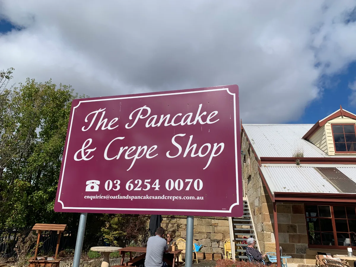 The bright purple sign for The Pancake & Crepe Shop, where we enjoyed a fantastic lunch.