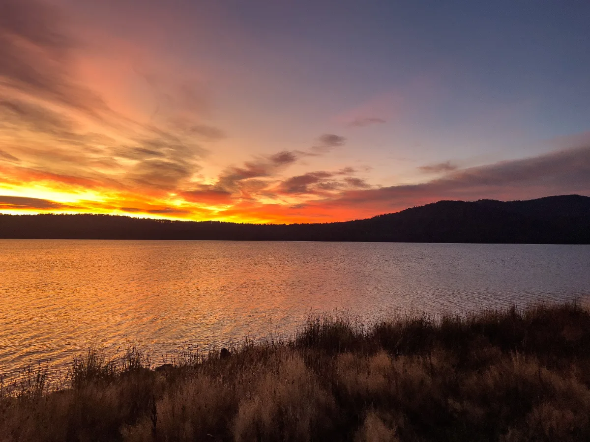 The sky putting on a brilliant orange and purple show for us at sunrise over Brady’s Lake.