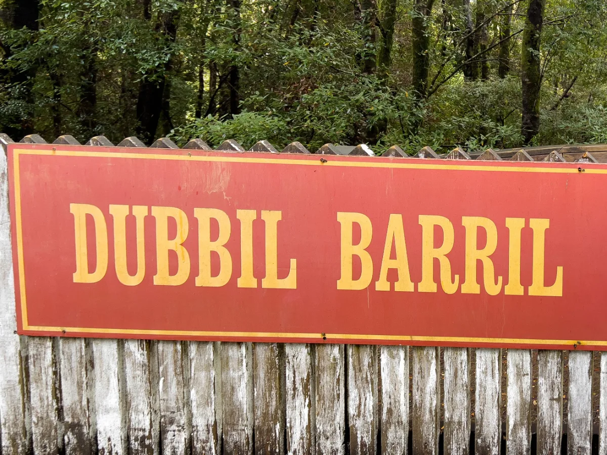 The iconic red and yellow station sign for Dubbil Barril, one of the historic stops along the wilderness track.