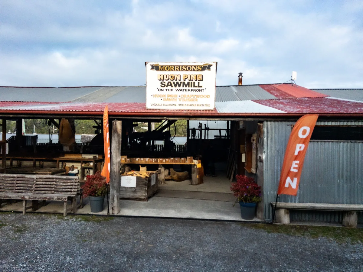 The entrance to Morrisons Huon Pine Sawmill, where the air is thick with the scent of ancient timber.