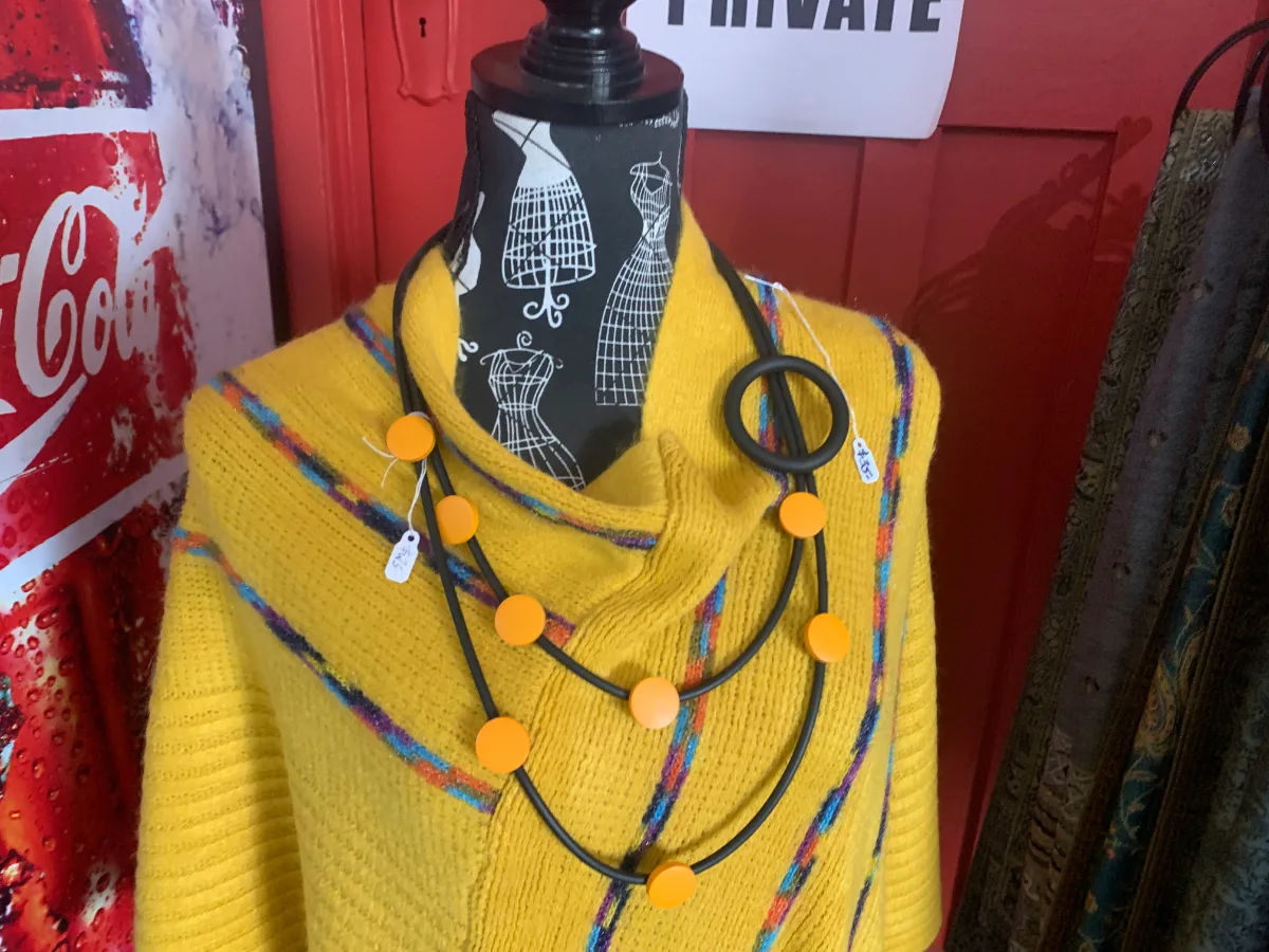 A bright yellow top and eye-catching necklace add a pop of colour to a Westonia shop window.