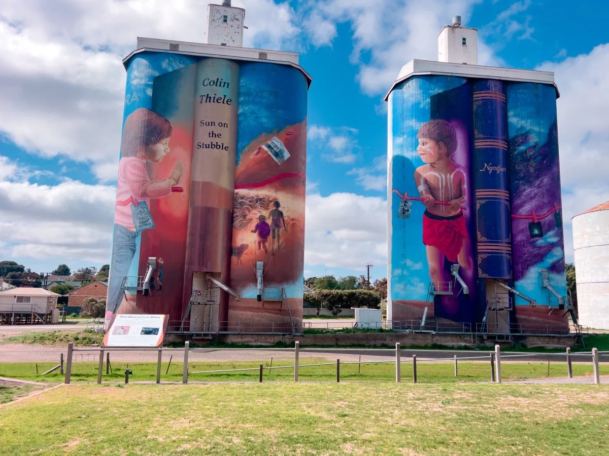 The Eudunda silos stand proudly, adorned with characters and scenes from Colin Thiele's books and local Indigenous stories. The murals transform these industrial structures into vibrant displays of art.
