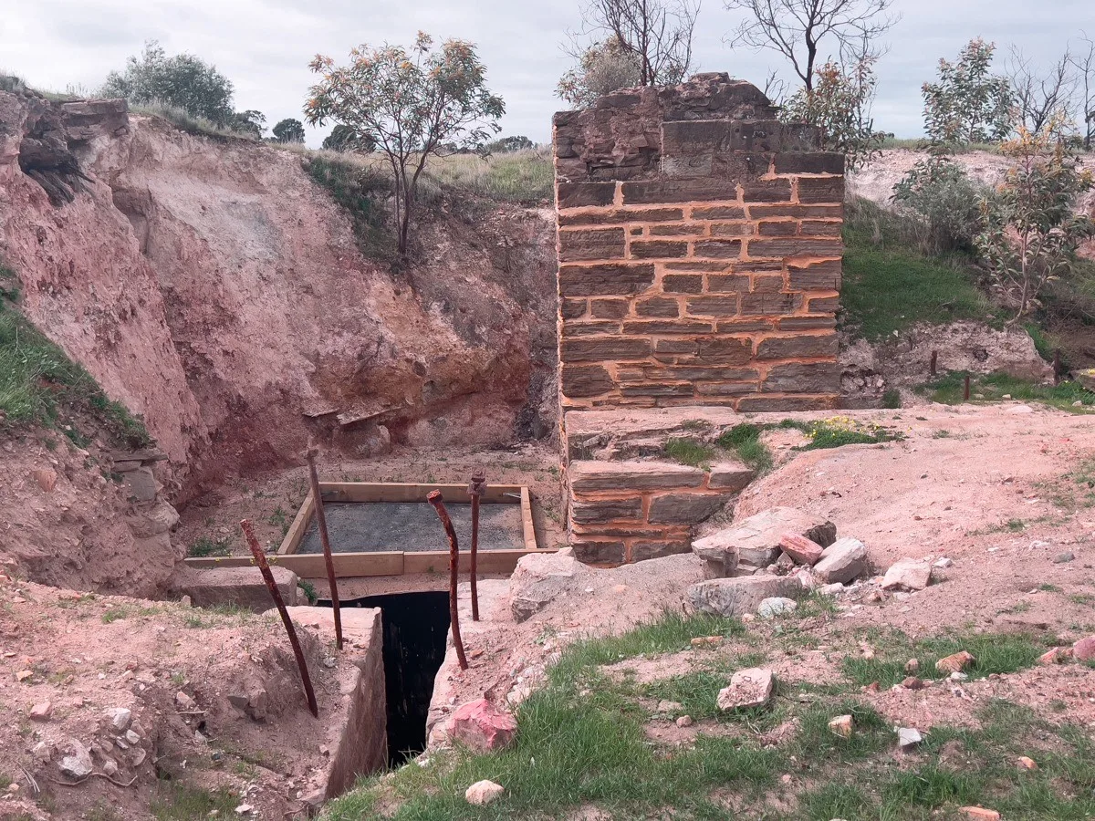 An excavated mine area in Kapunda. The remnants of a structure hints at the massive operation that once occurred.