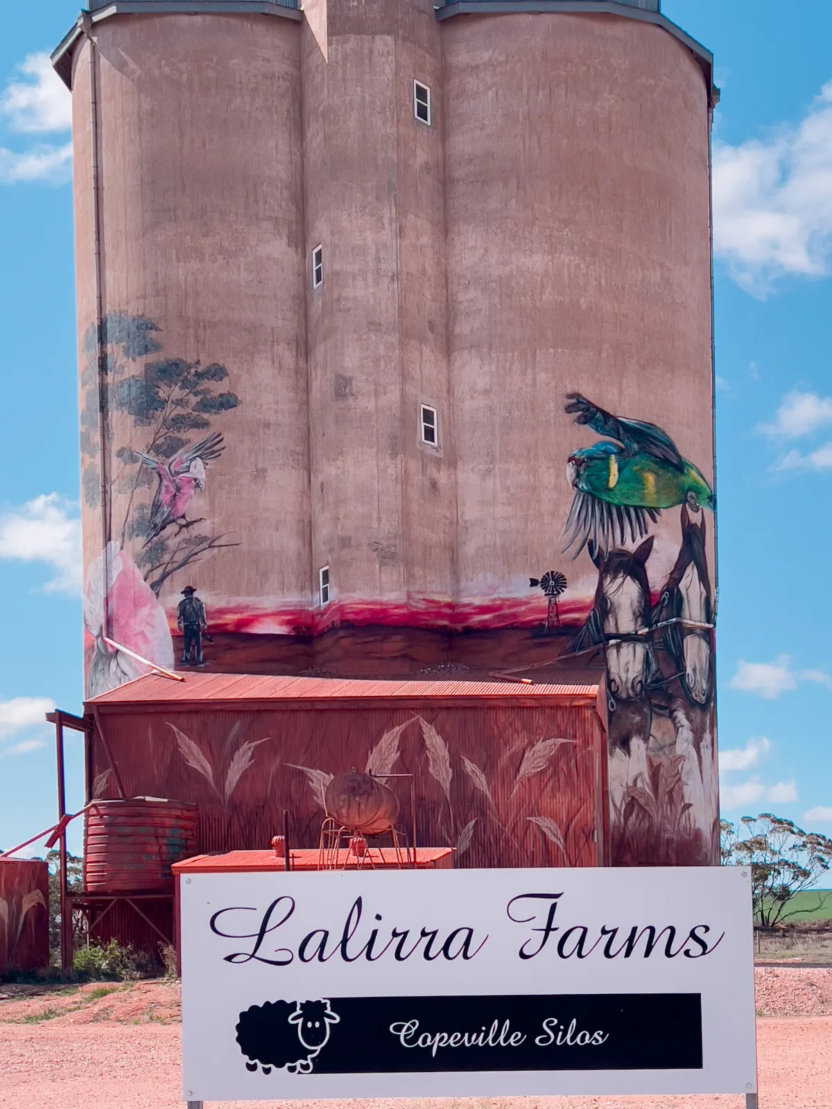 The Lalirra Farms sign sits below the Copeville Silo Art, hinting at the agricultural heart of this rural community.