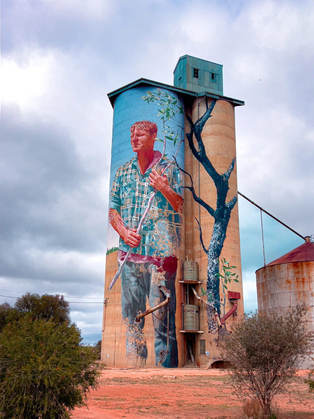 The towering mural of a young farmer, a striking representation of the Mallee's agricultural heritage, dominates the Patchewollock skyline.