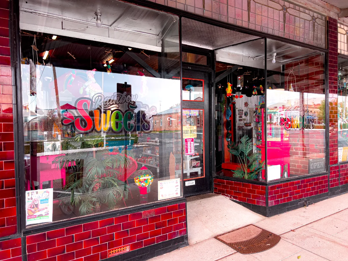 The colourful shop front of Rainbow Sweets, tempting us with nostalgic treats.