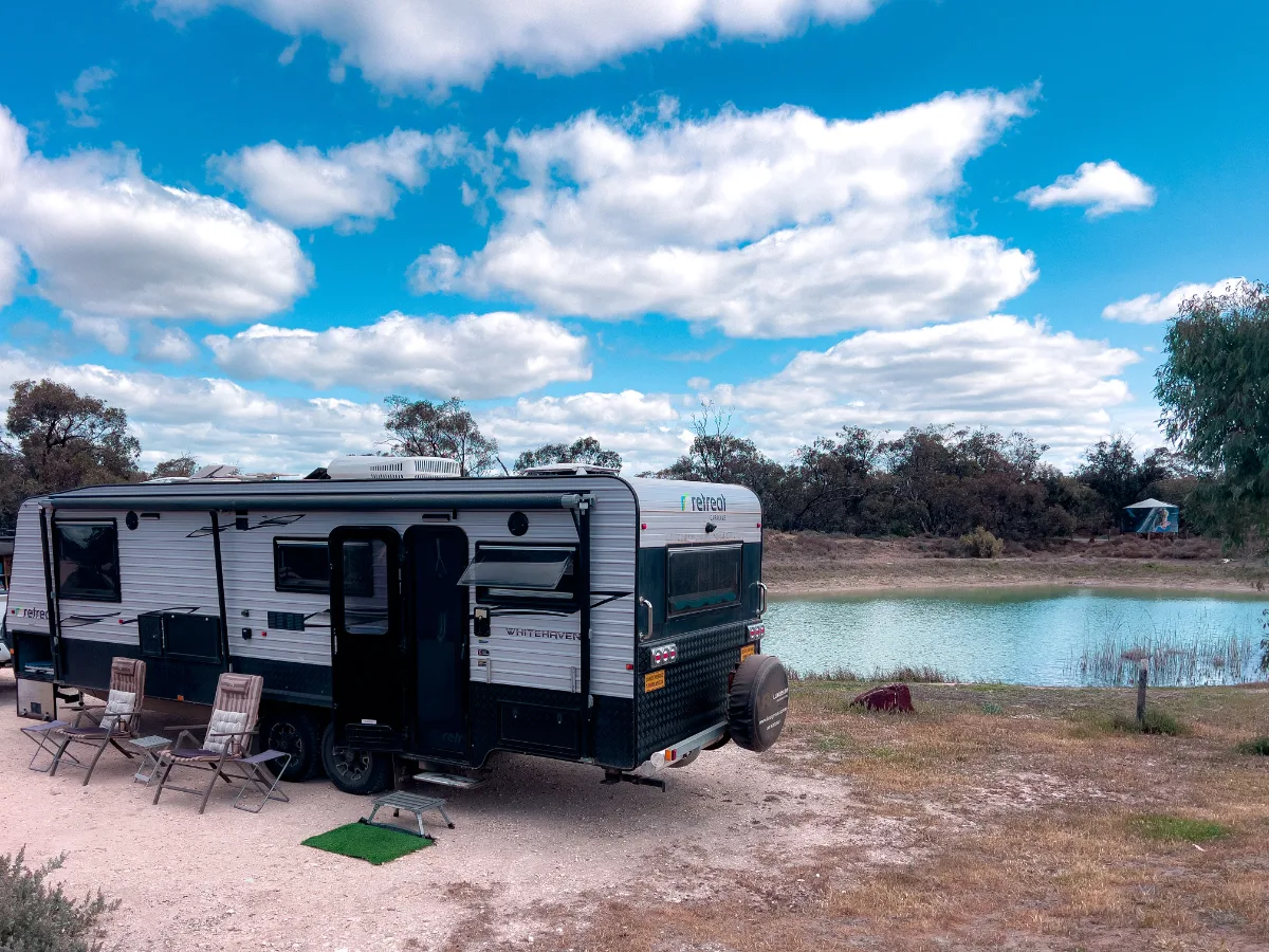 A peaceful waterside view at Woomelang. The water glistens in the sun as the puffy clouds roll on by.