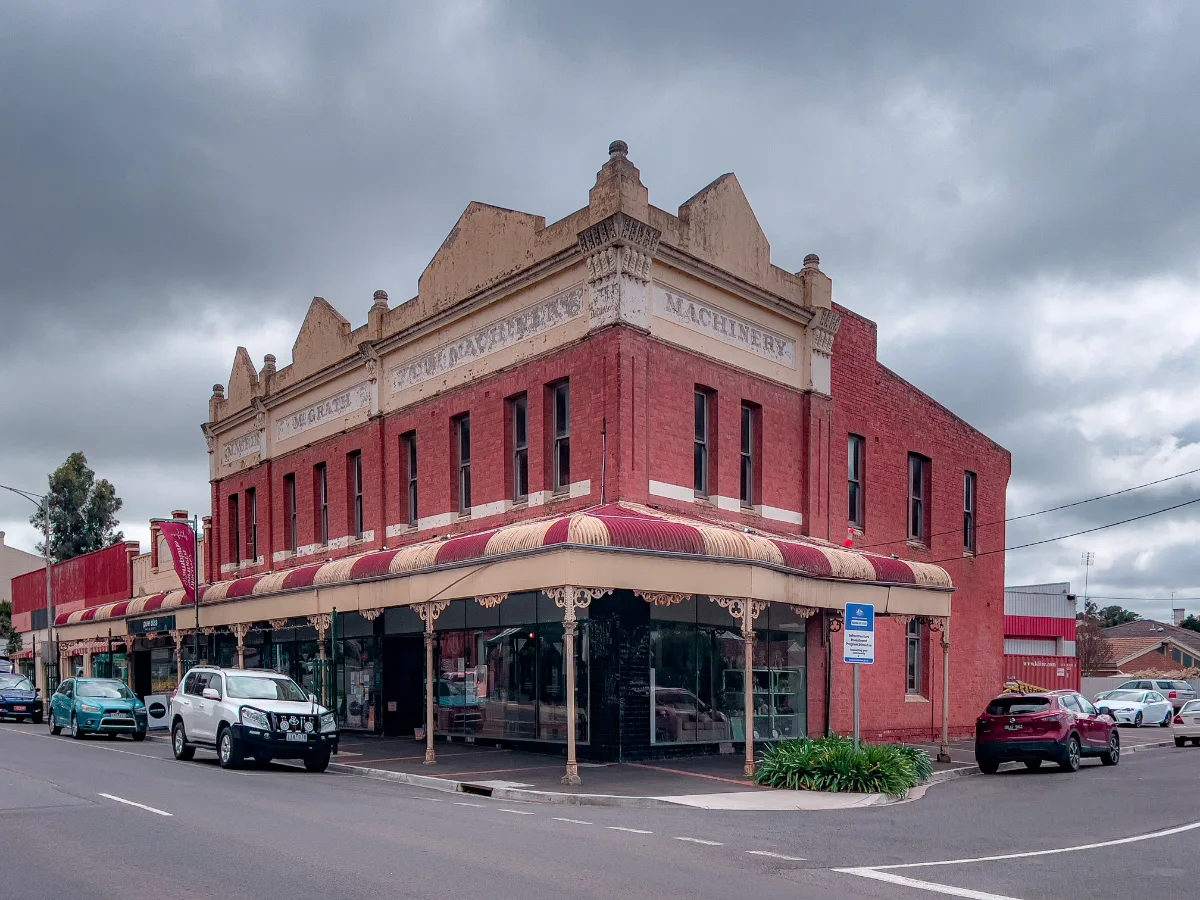 A grand corner building on a gloomy day in St Arnaud. The faded awnings and aged brickwork tell a story of a town with a rich history, slowly decaying in the elements.
