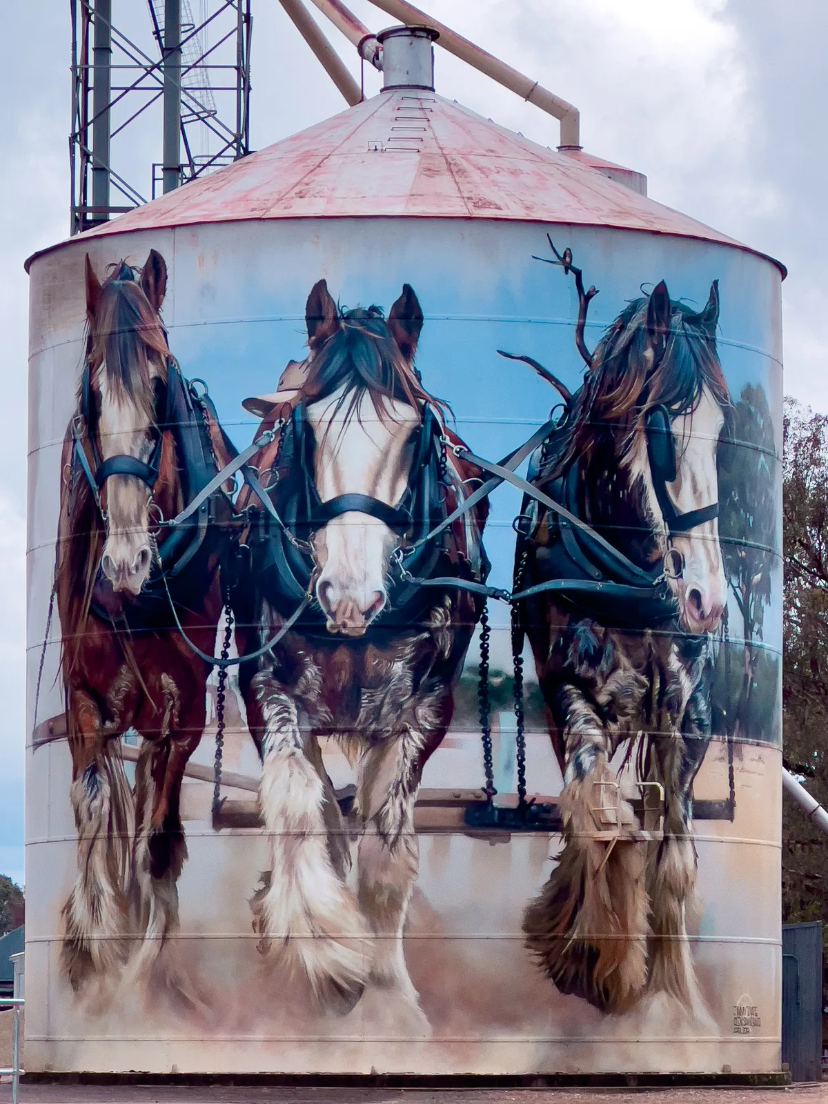 Three Clydesdales depicted on a silo in Goorambat, Victoria, showcasing the animals that were indispensable to the region's agricultural heritage.
