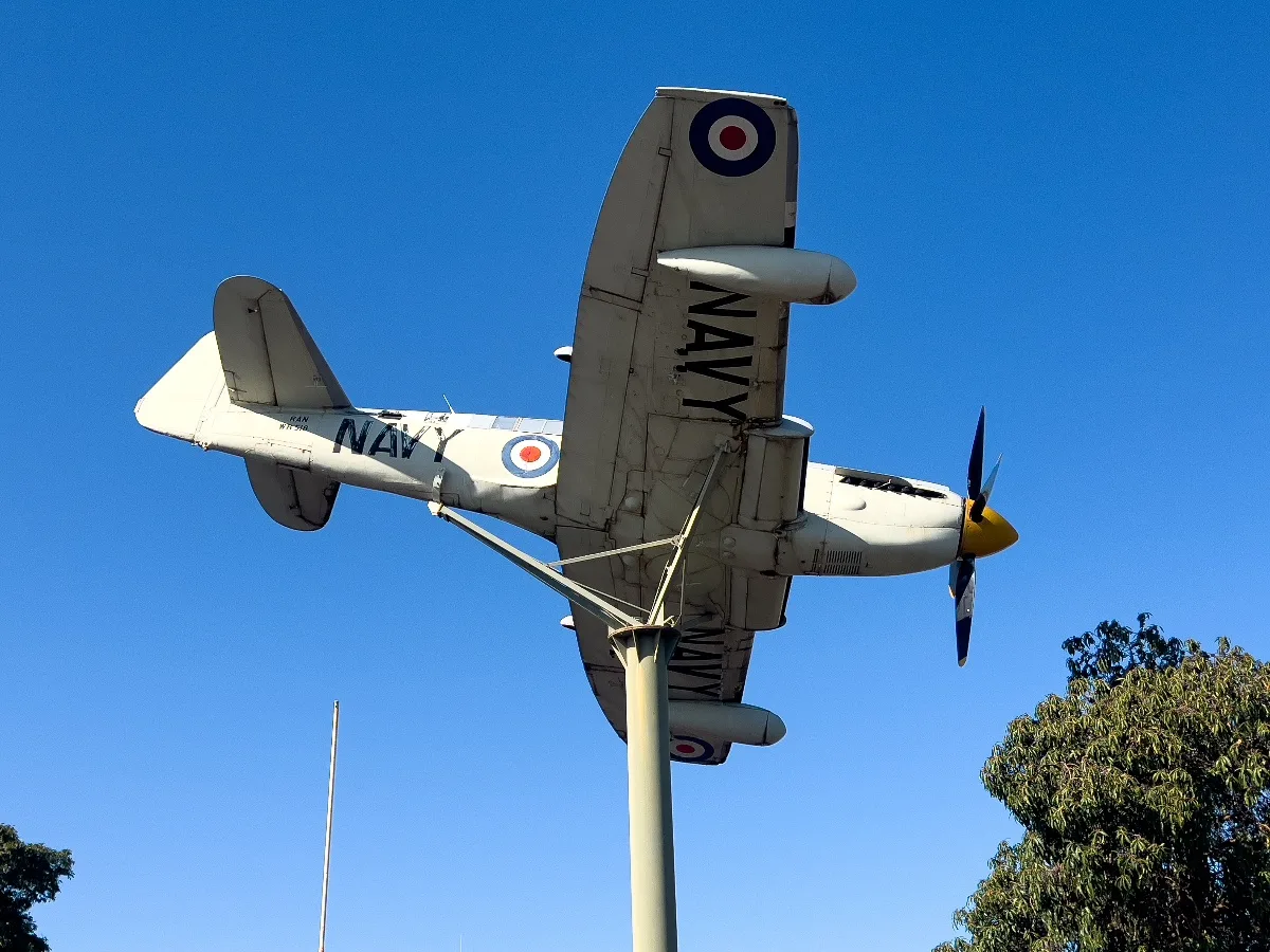 The Fairey Firefly stands as a silent sentinel against a brilliant blue sky in Collina.