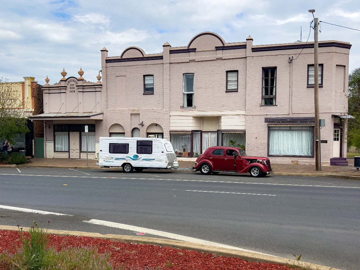 A vintage car provides a lovely juxtaposition to the buildings in town. Note our caravan in the background.