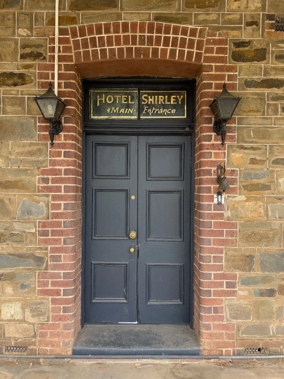 A close-up of the main entrance to Hotel Shirley, a name that evokes both curiosity and amusement.