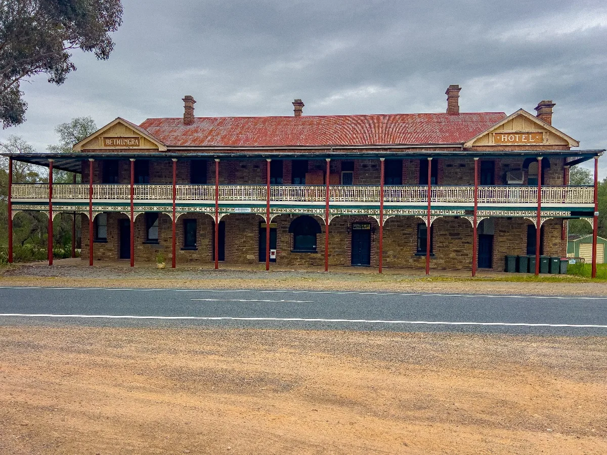 The grand, yet decaying, facade of the Bethungra Hotel, a silent sentinel beside the road.