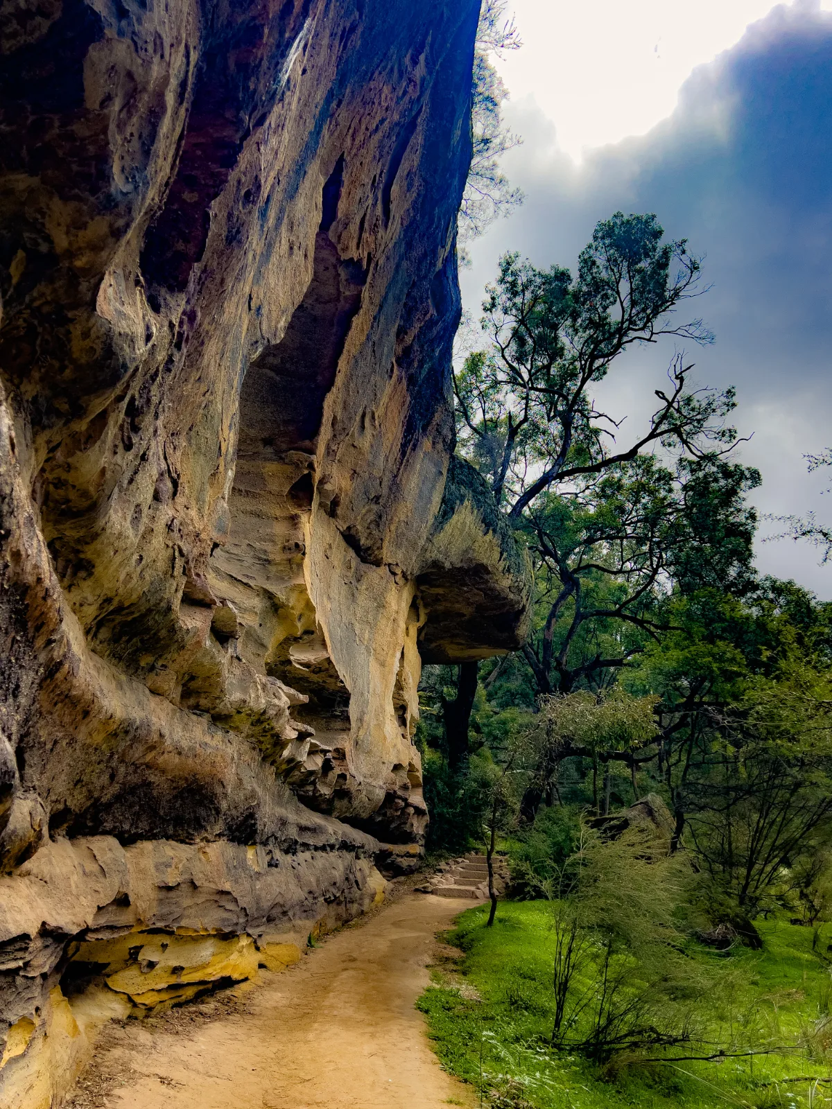 The walkway alongside the sandstone cliff revealed the area's rugged charm.